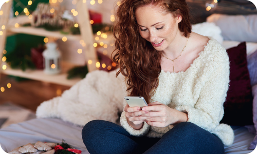 woman using phone to purchase online during holiday sales